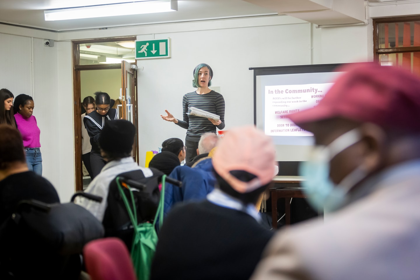 Woman presenting information at a community meeting.