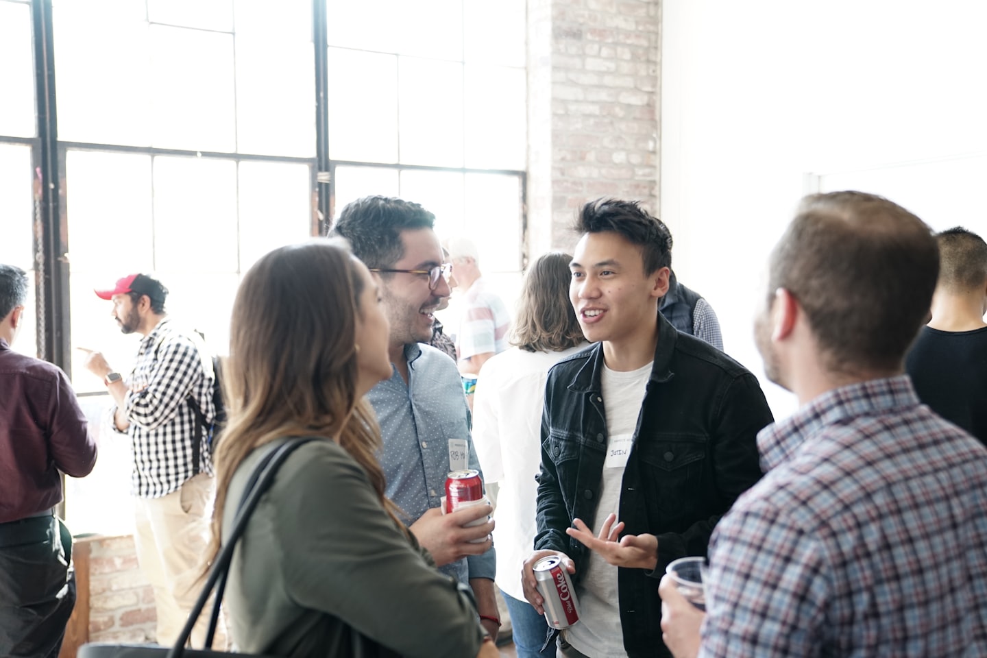 Diverse professionals networking and conversing at an indoor event.